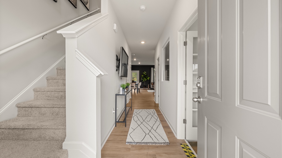 Interior entry-way open to staircase and living area