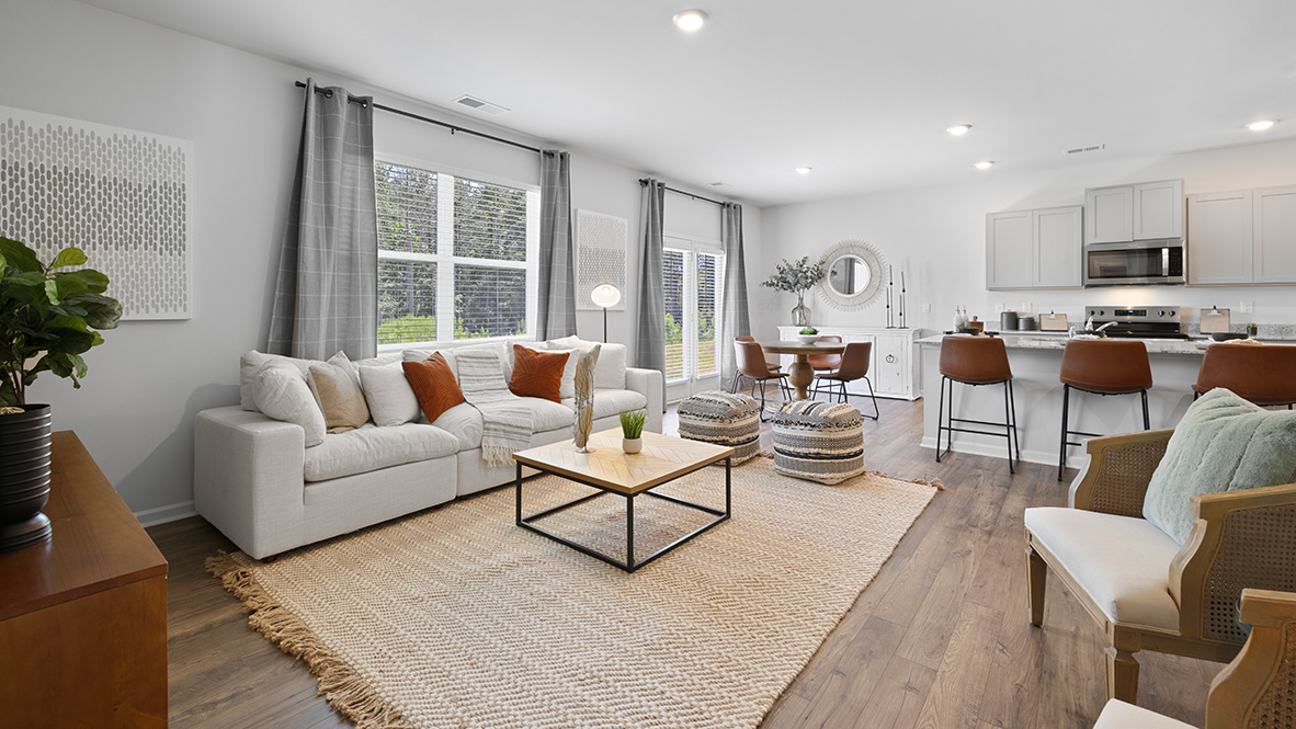 hayden model home living room with hardwood flooring and large windows