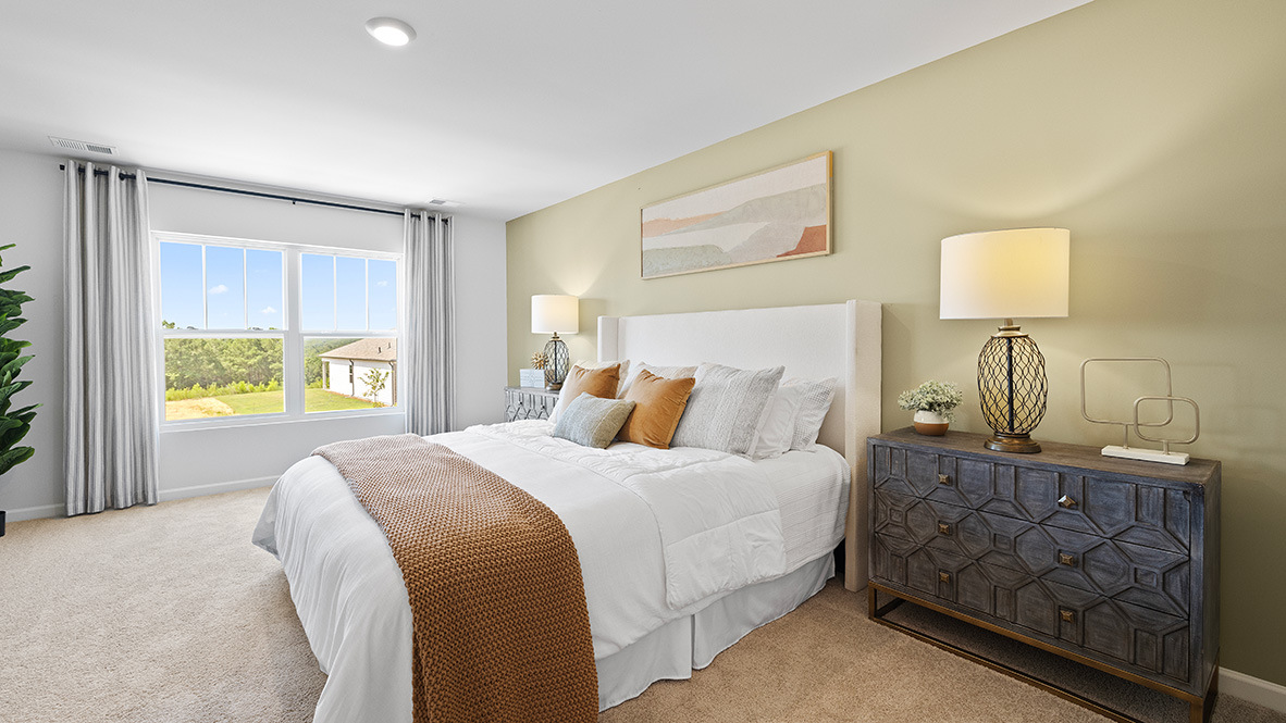 hayden primary suite bedroom at model home in oaks at cedar grove