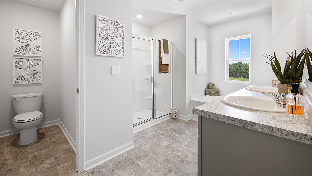 hayden primary suite bedroom at model home in oaks at cedar grove