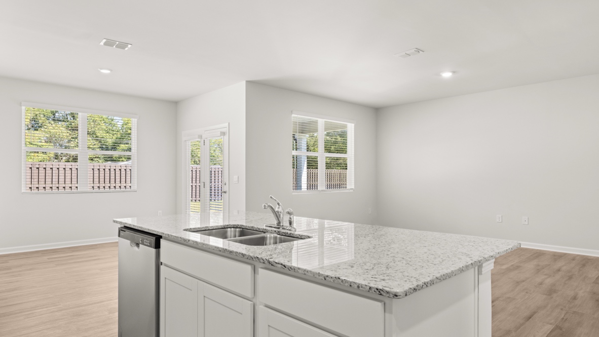 Interior kitchen with center island and white cabinets