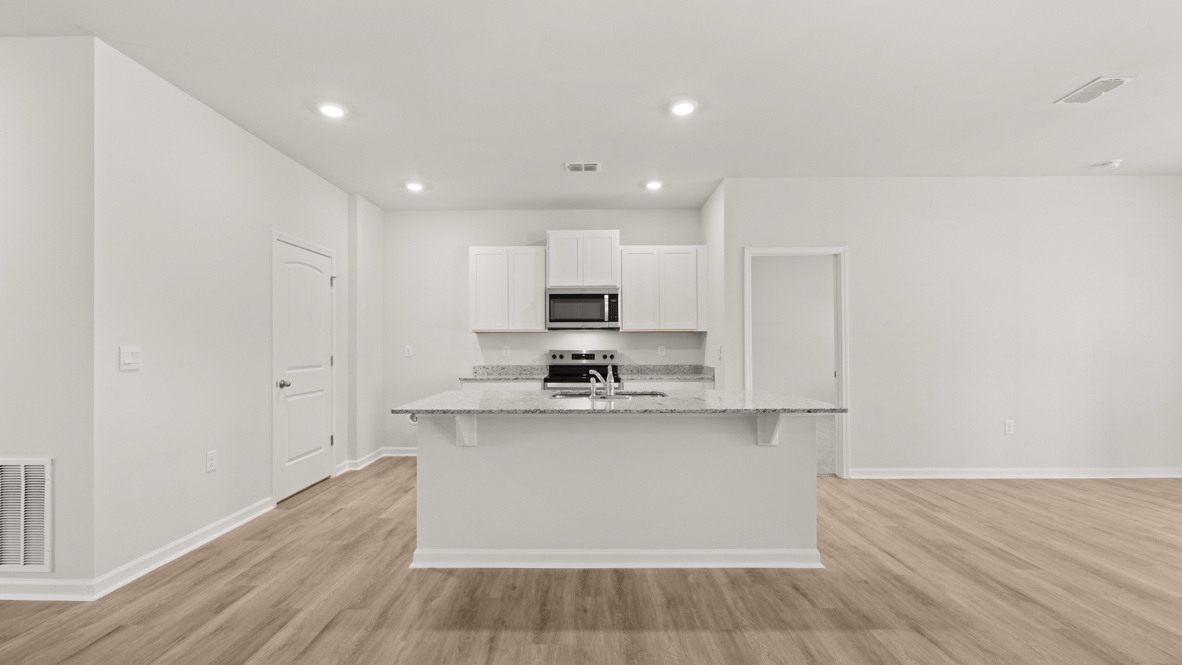 Interior kitchen with center island and white cabinets