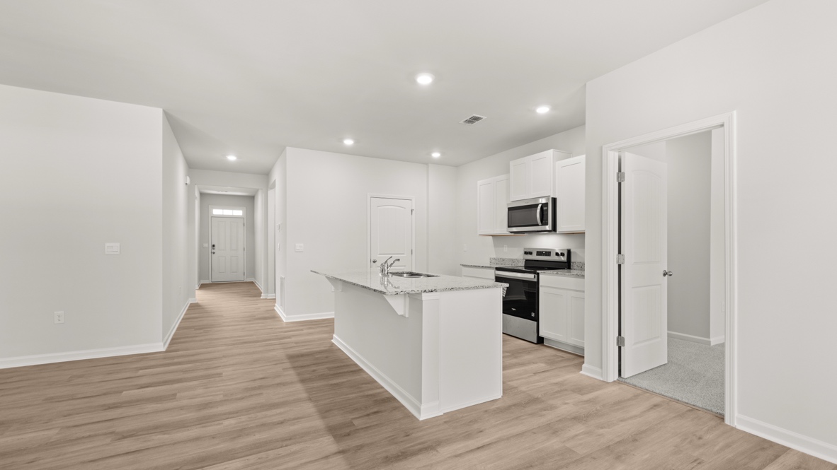 Interior kitchen with center island and white cabinets
