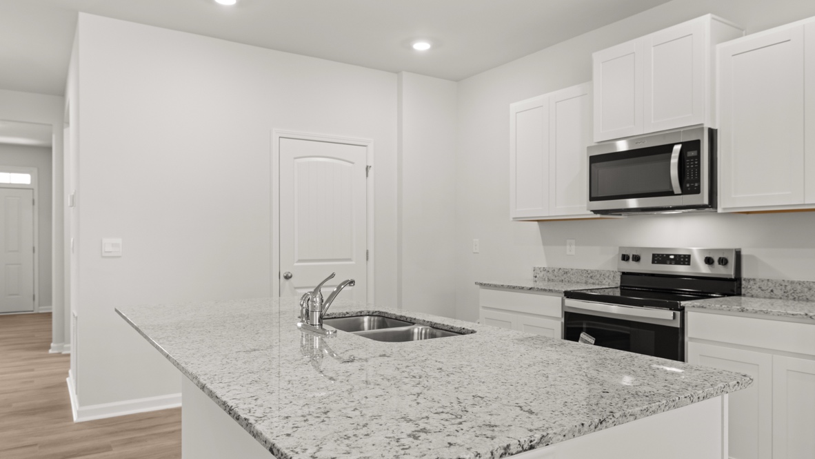 Interior kitchen with center island and white cabinets