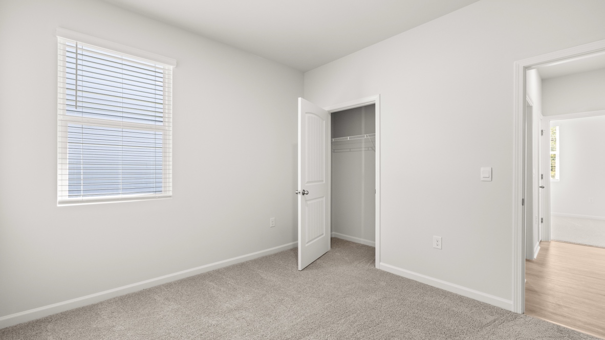 Interior bedroom with window and closet