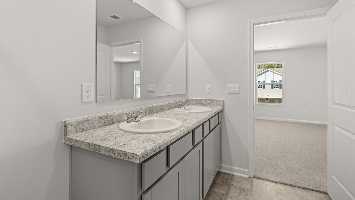 Interior primary bedroom with double sink