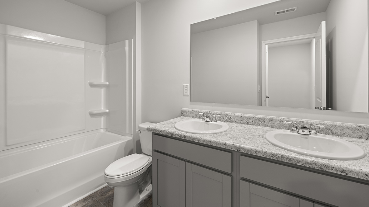 Interior bathroom with double sink and full-sized shower