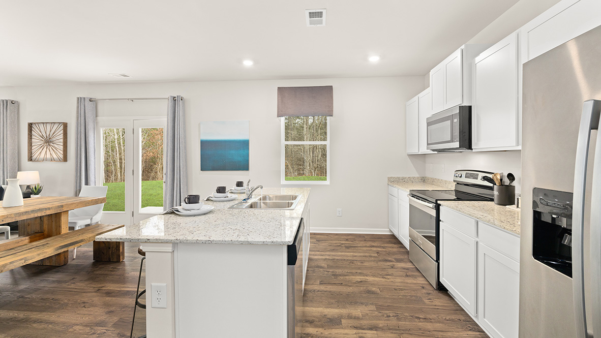 Interior kitchen with center island and white cabinets