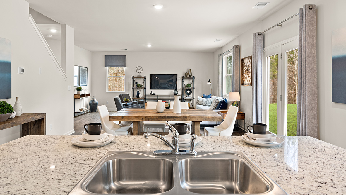 Interior kitchen with center island and white cabinets