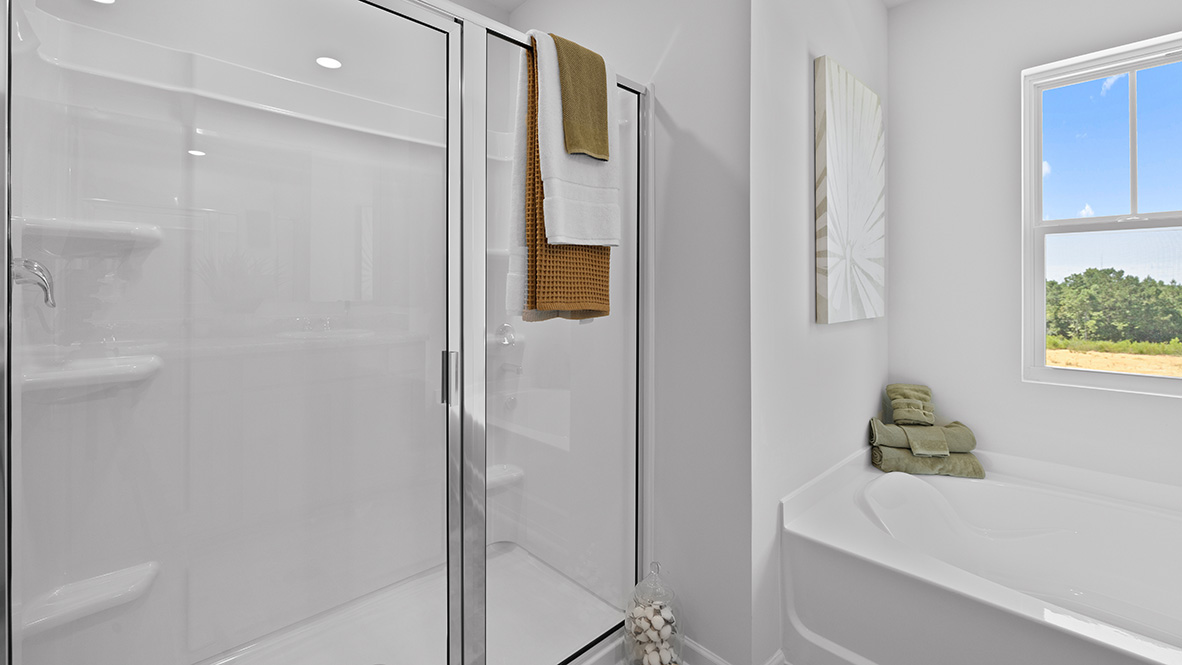 Interior primary bathroom with shower and bath tub