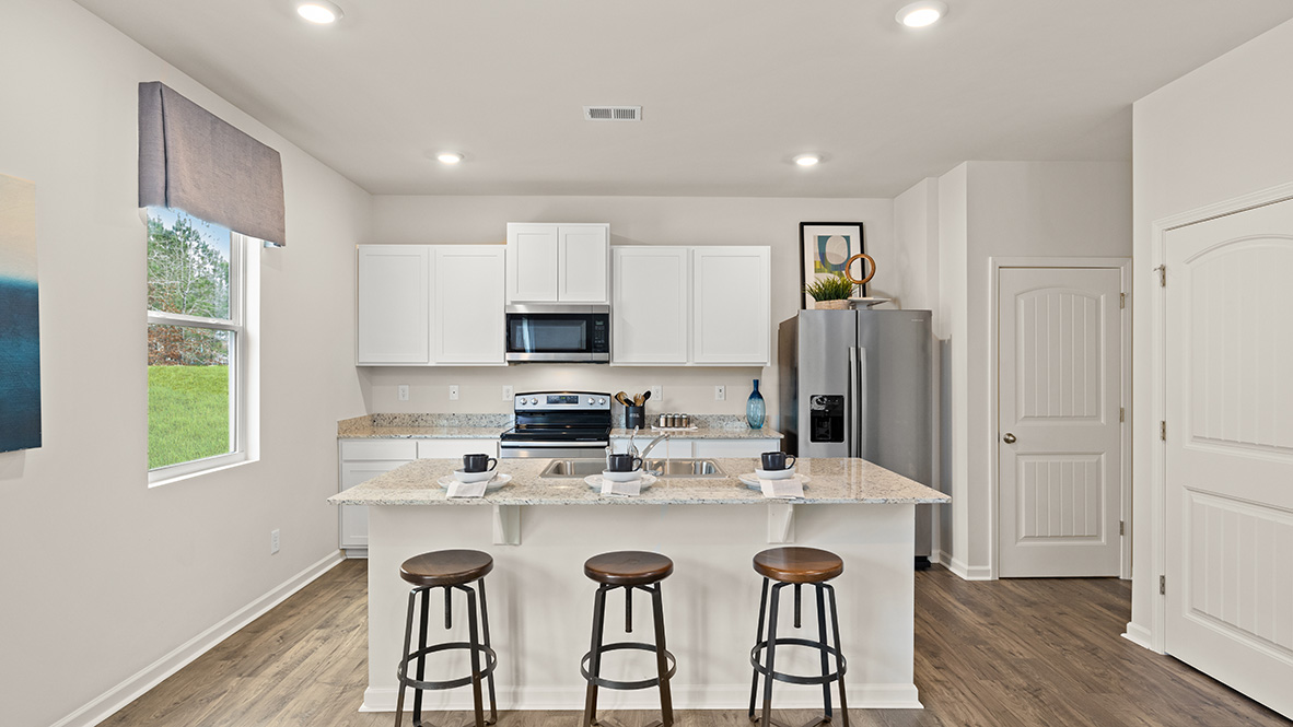 Interior kitchen with center island and white cabinets