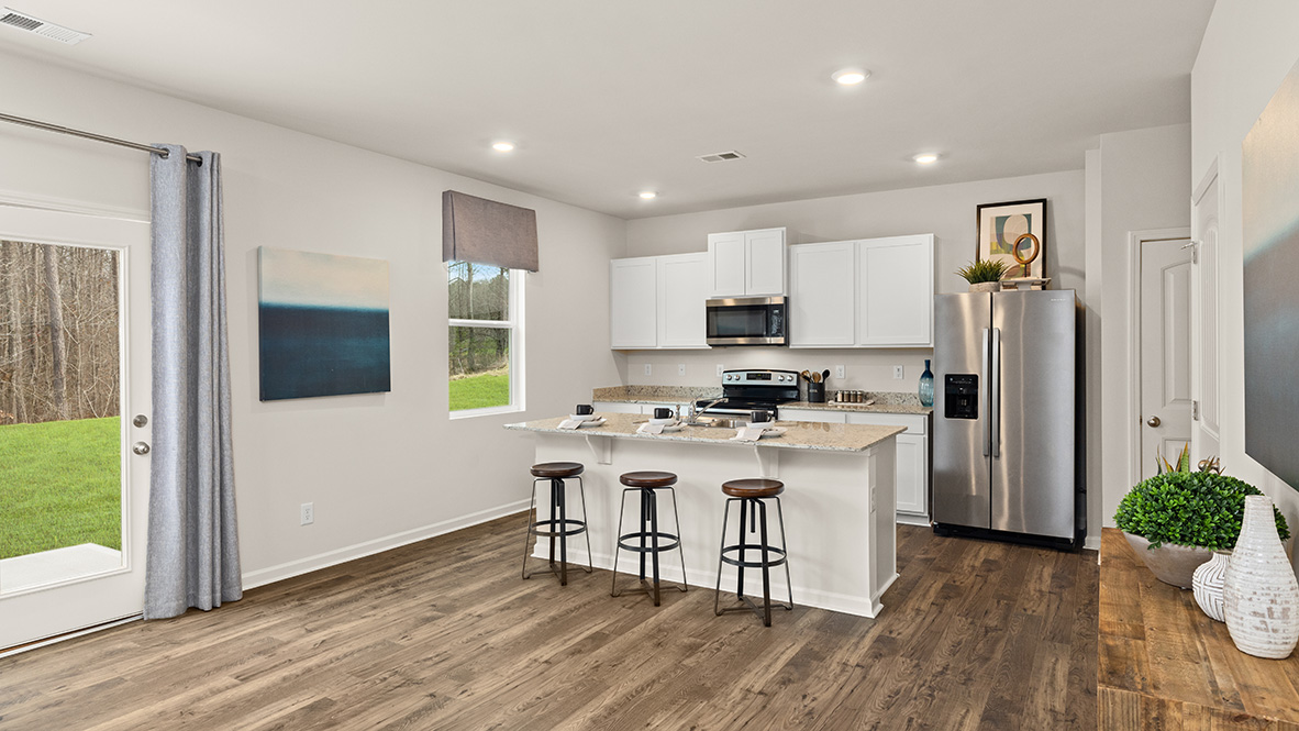 Interior kitchen with center island and white cabinets