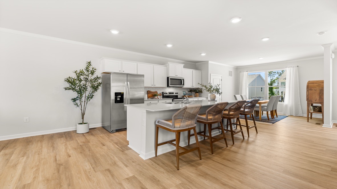 Interior kitchen with center isladn and white cabinets