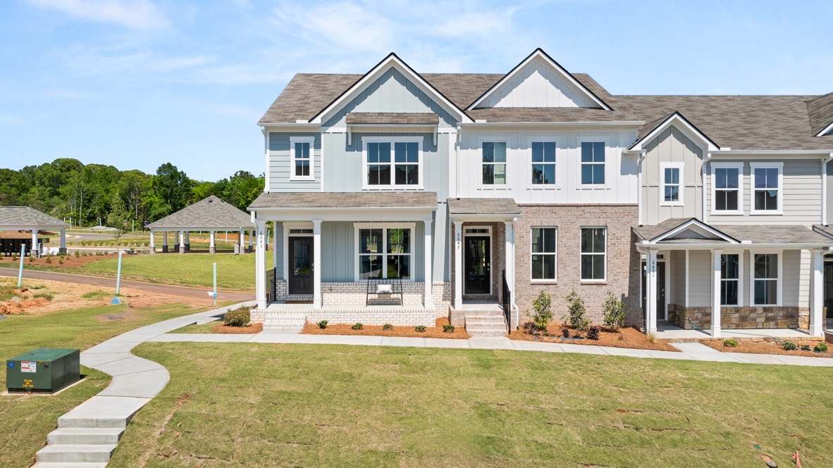 Exterior two-story townhomes with cladding and stone detailing