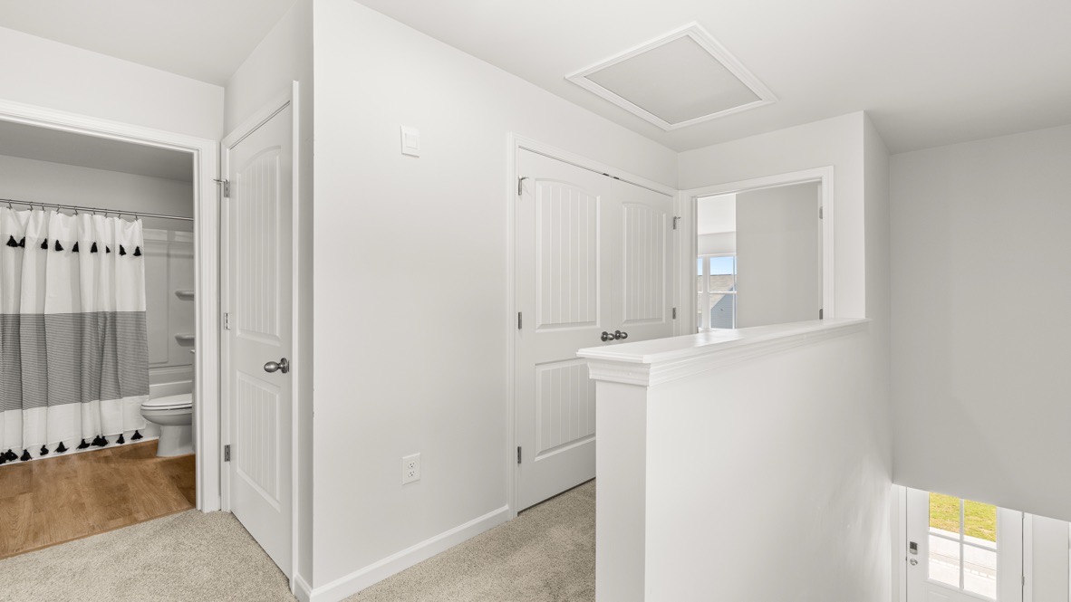 Interior upstairs loft area open to staircase and large window
