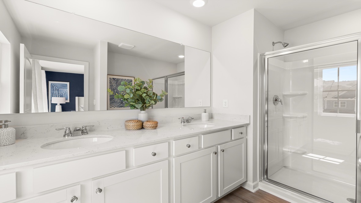 Interior primary bathroom with double sink and shower