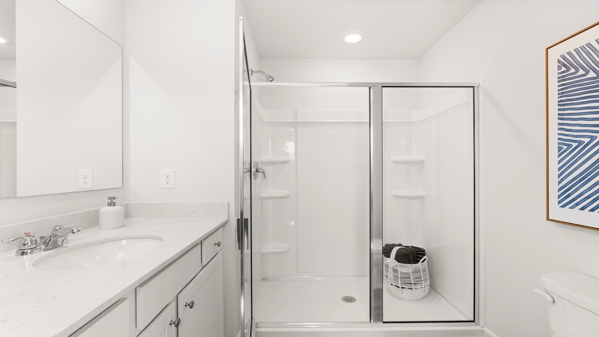 Interior primary bathroom with double sink and shower
