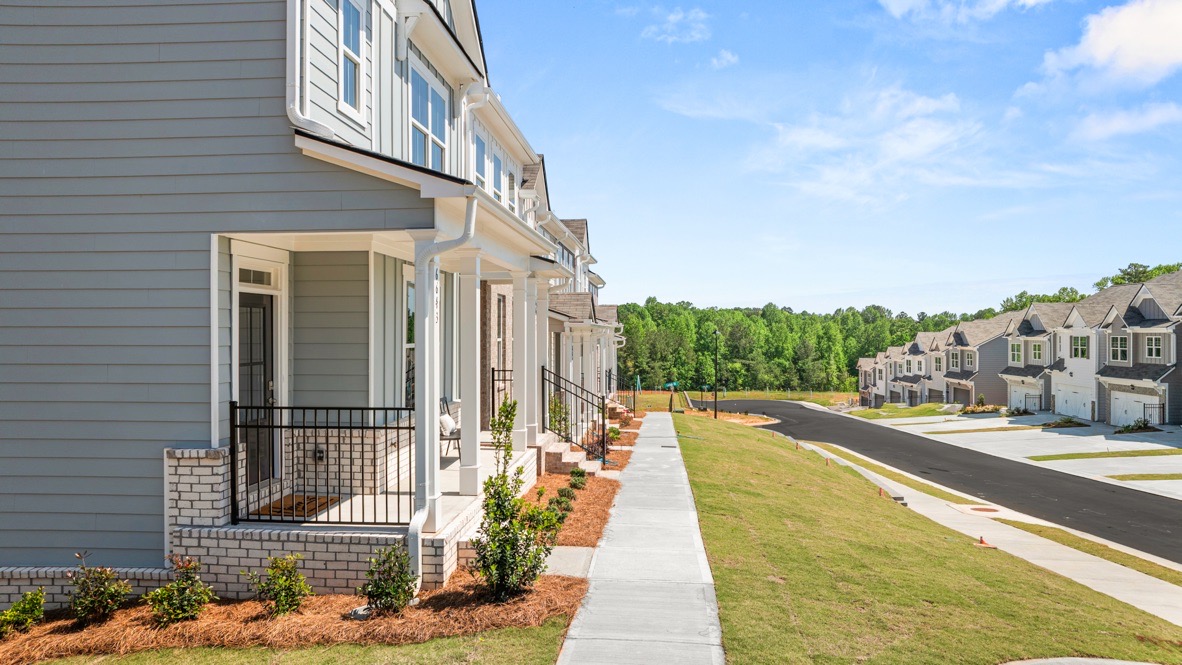 Exterior two-story townhomes with cladding and stone detailing
