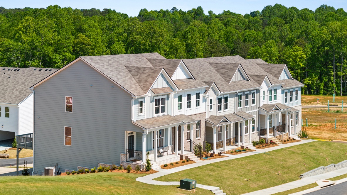 Exterior two-story townhomes with cladding and stone detailing