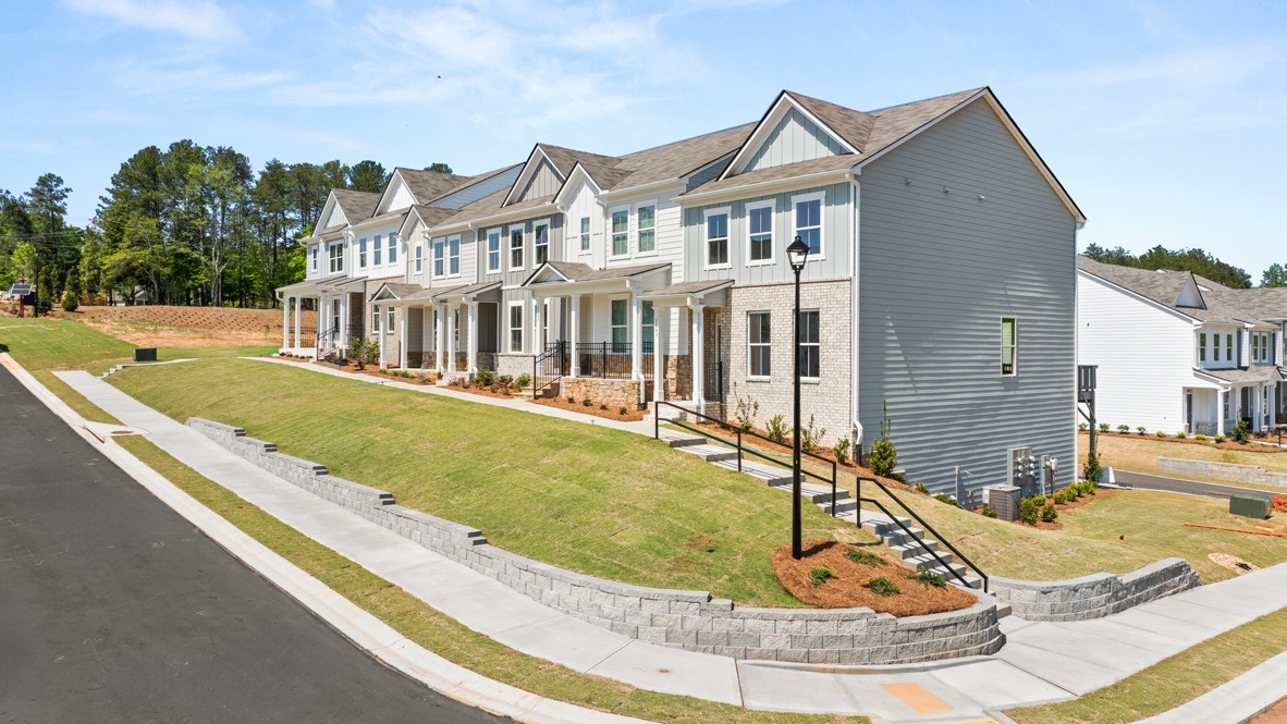 Exterior two-story townhomes with cladding and stone detailing