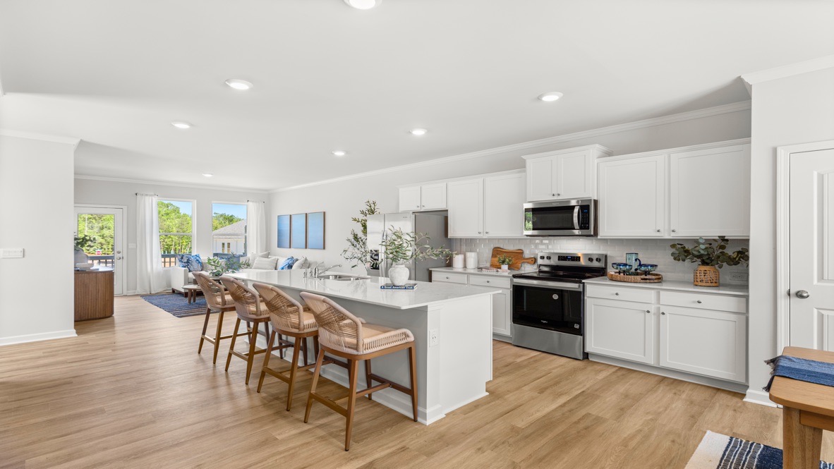 Interior kitchen with center island and white cabinets