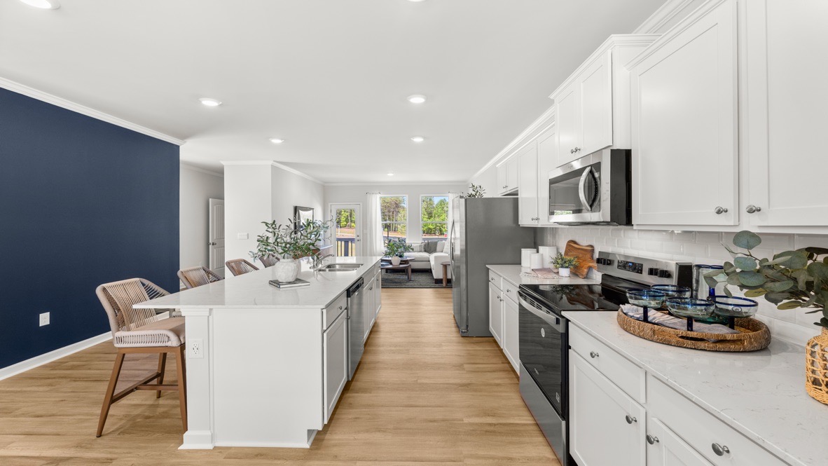 Interior kitchen with center island across from blue accent wall