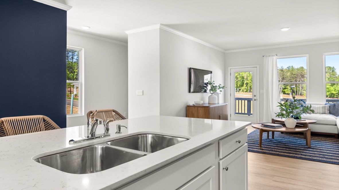 Interior kitchen with center island across from blue accent wall