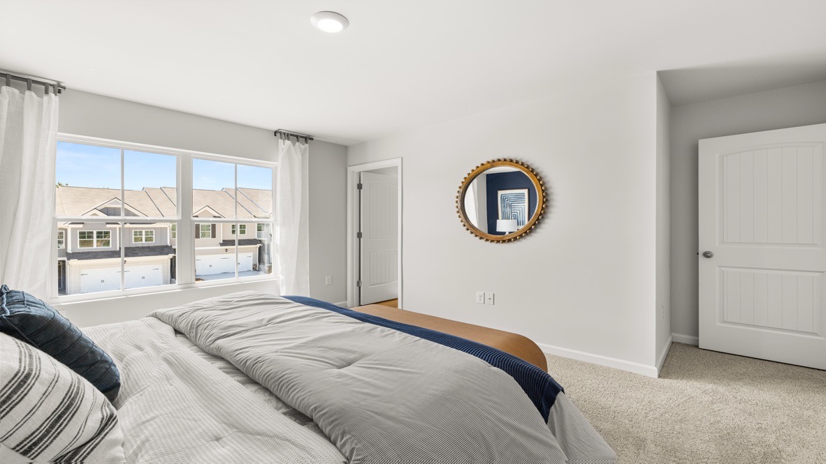 Interior primary bedroom with large window