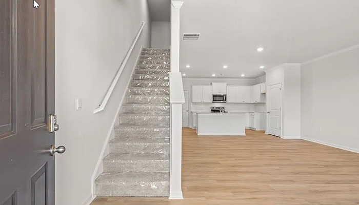 Interior entry-way leading to living area and kitchen with center island