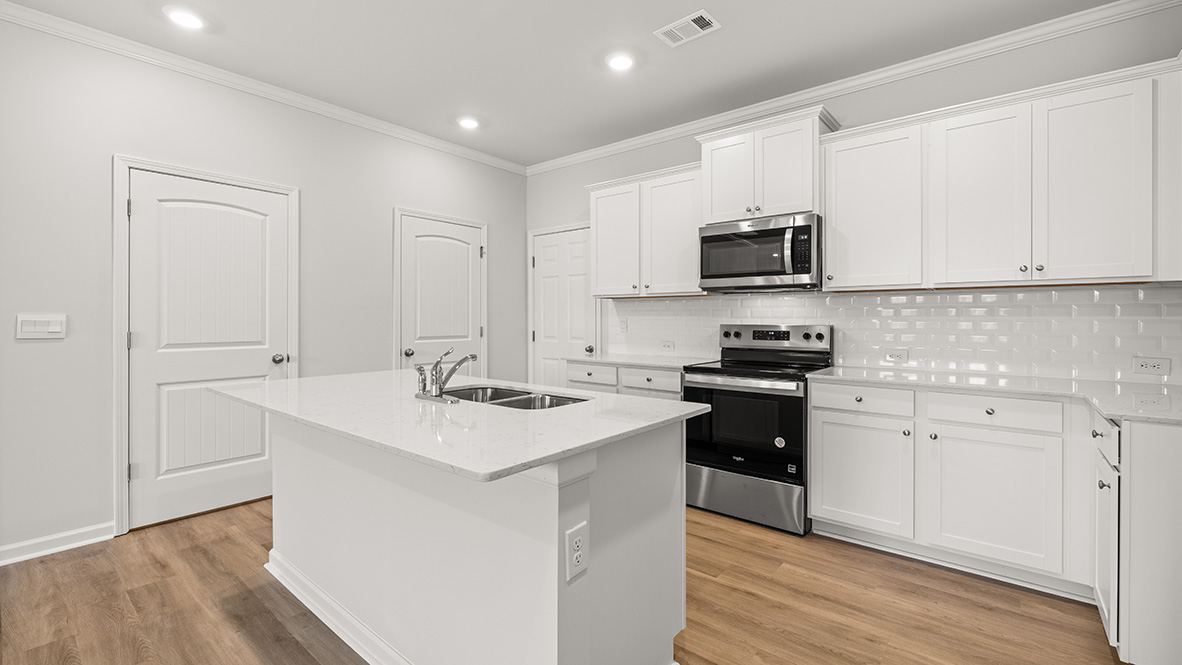 kitchen with white cabinetry, large island and stainless steel appliances