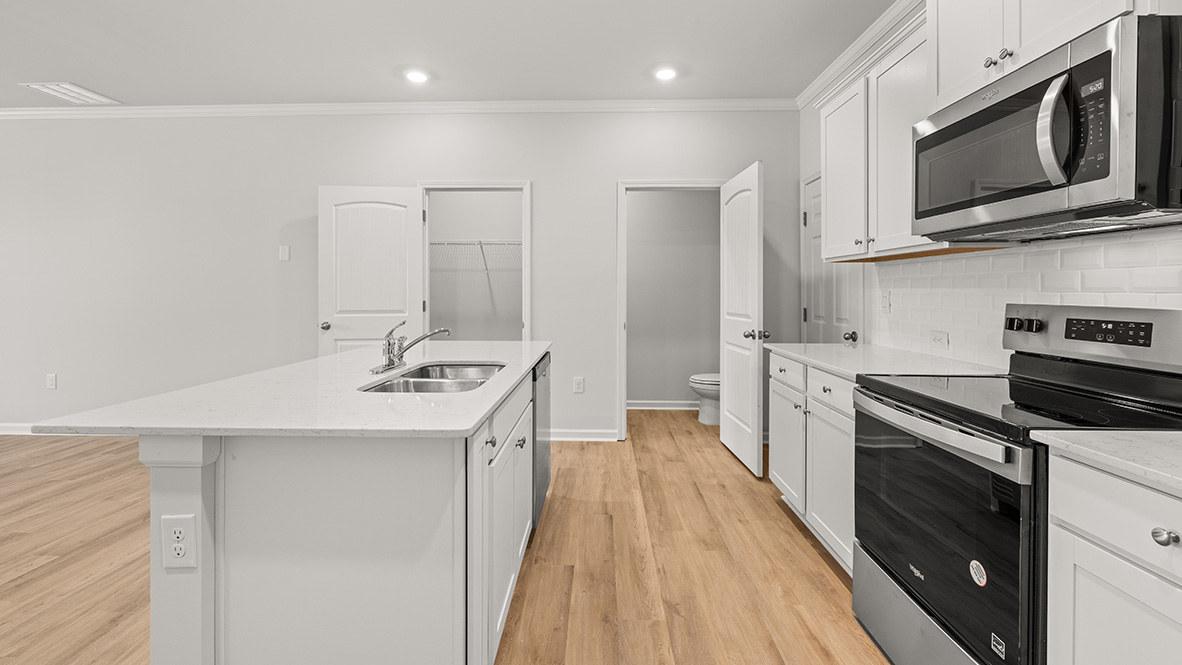 kitchen with white cabinetry, large island and stainless steel appliances