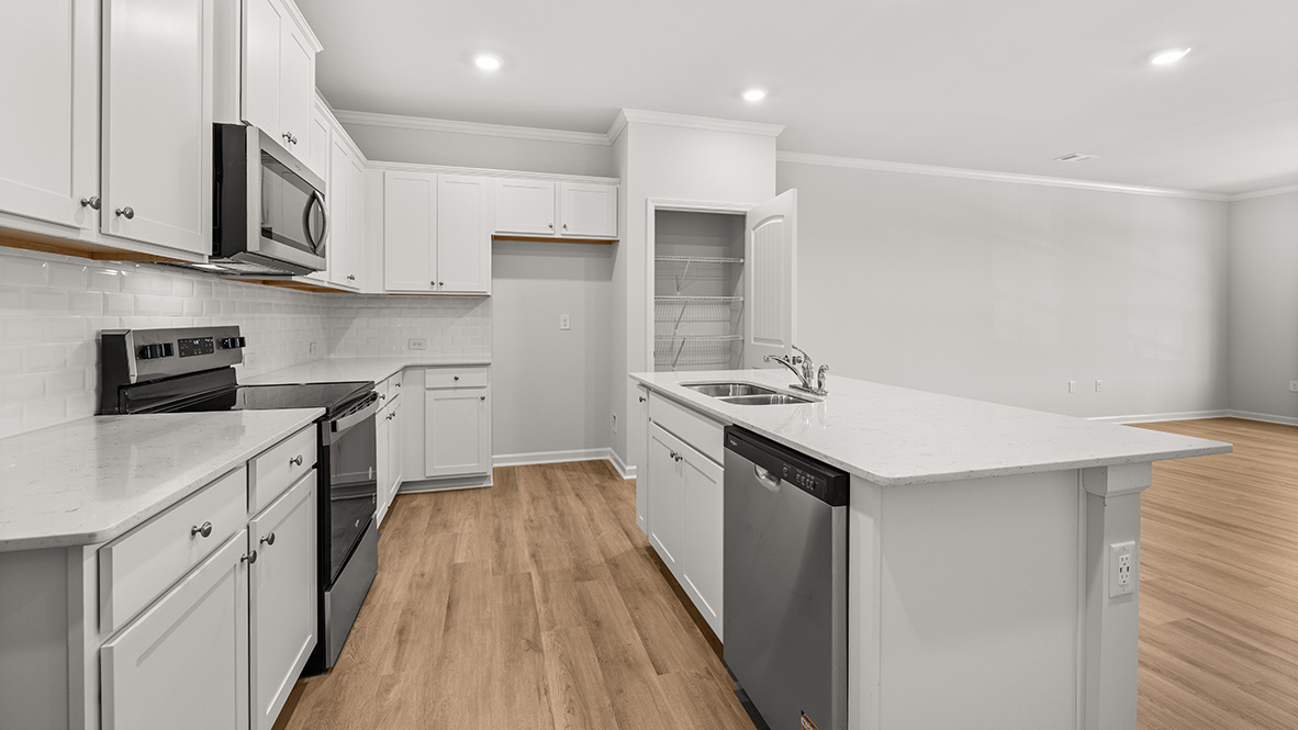 kitchen with white cabinetry, large island and stainless steel appliances