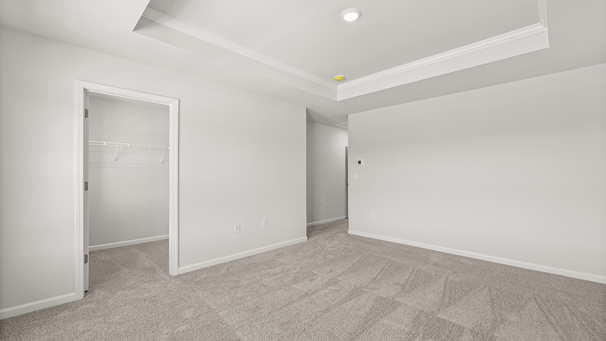 View of bedroom overlooking the closet and hallway doors