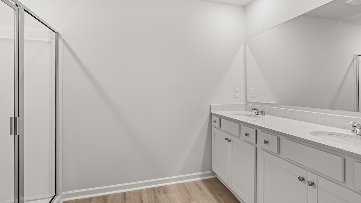 bathroom with dual vanity sinks, toilet, bath tub and a walk in shower