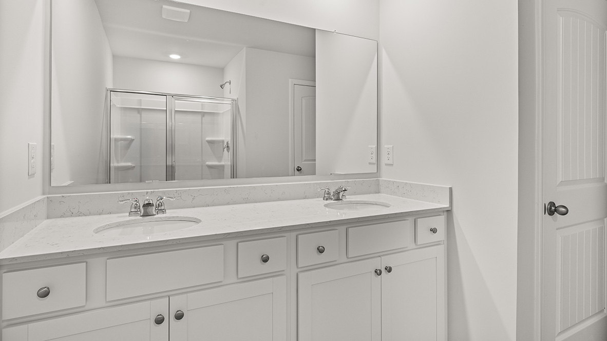 bathroom with dual vanity sinks, toilet, bath tub and a walk in shower