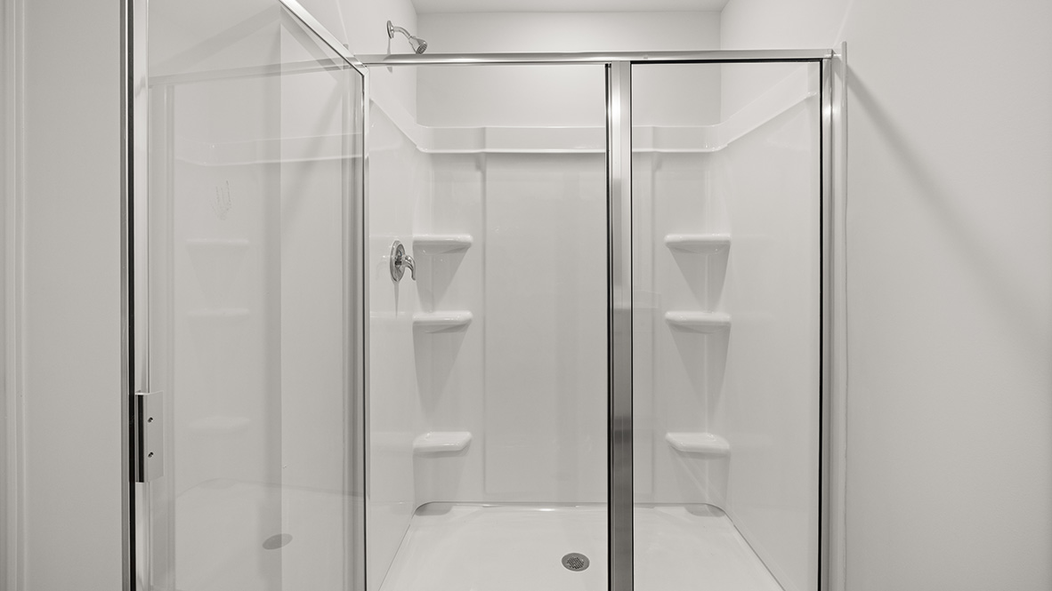 bathroom with dual vanity sinks, toilet, bath tub and a walk in shower