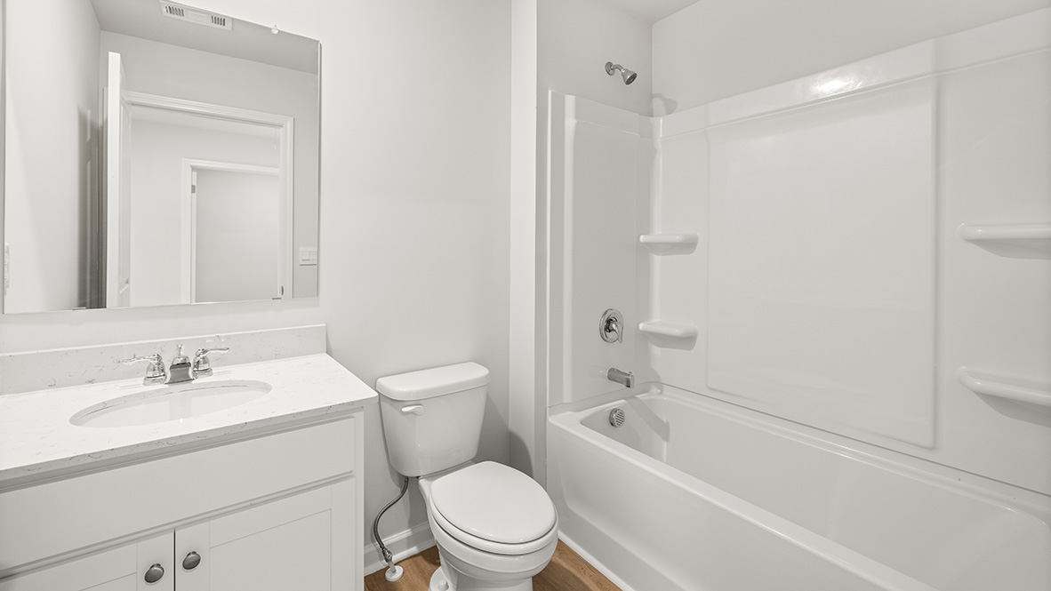 bathroom with a vanity sink, toilet and shower