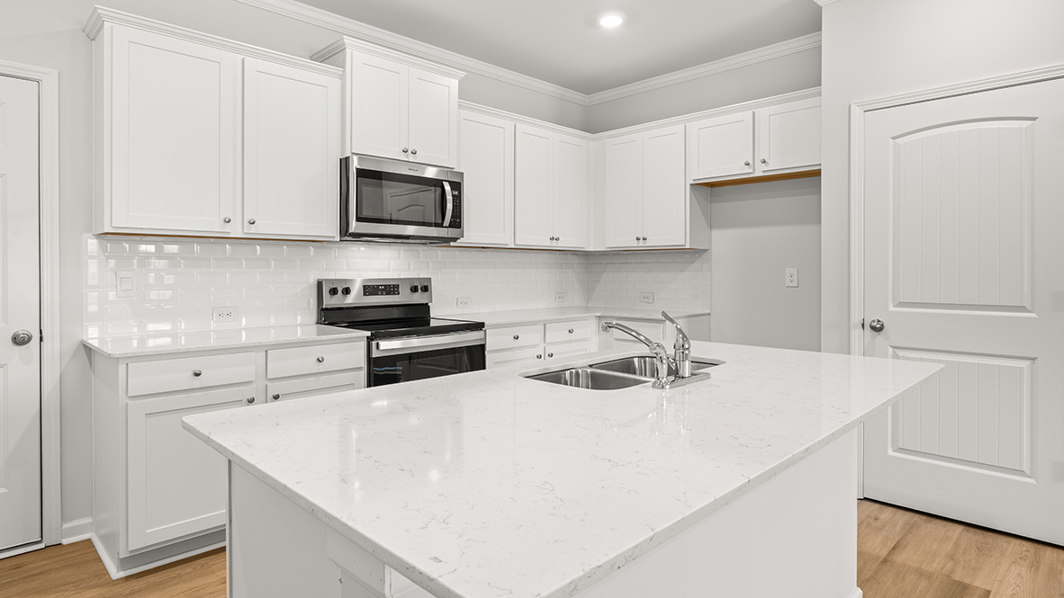 kitchen with white cabinetry, large island and stainless steel appliances