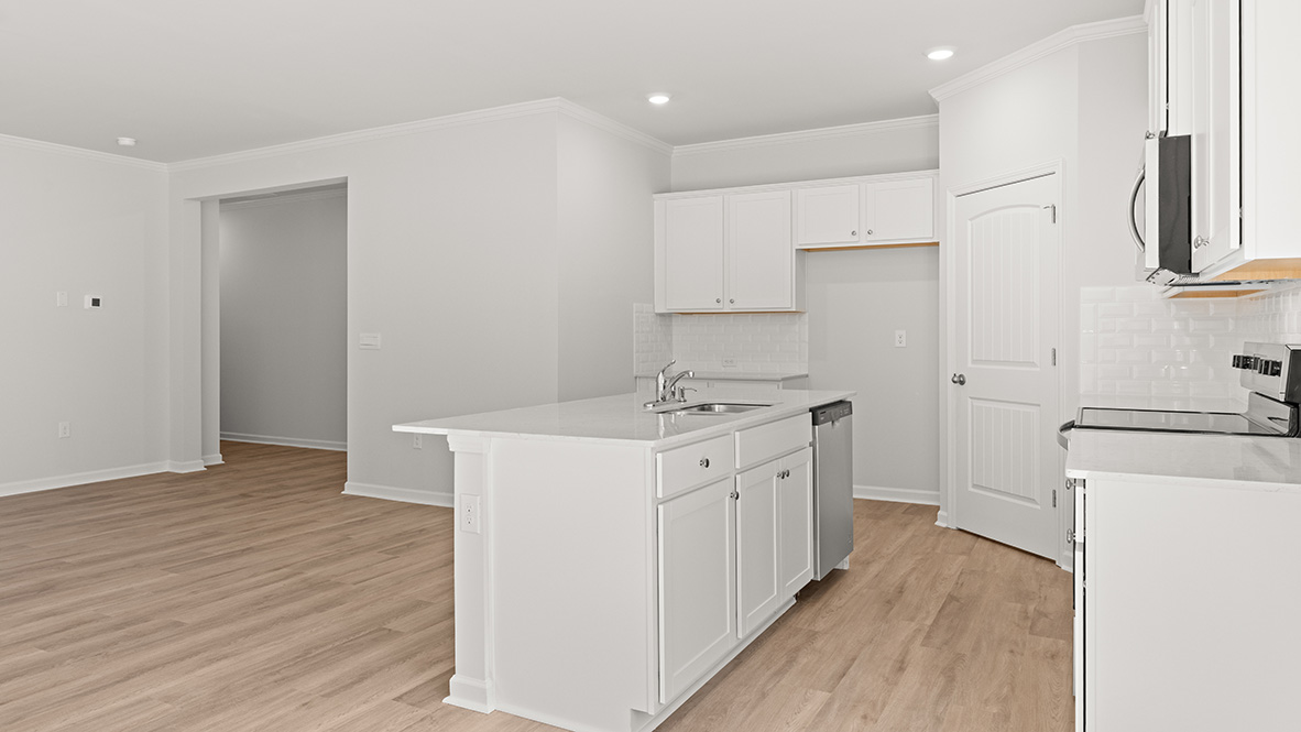 Interior kitchen with center island and white cabinets