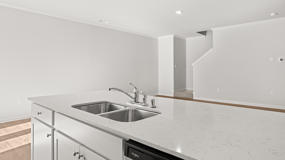 Interior kitchen with center island and white cabinets