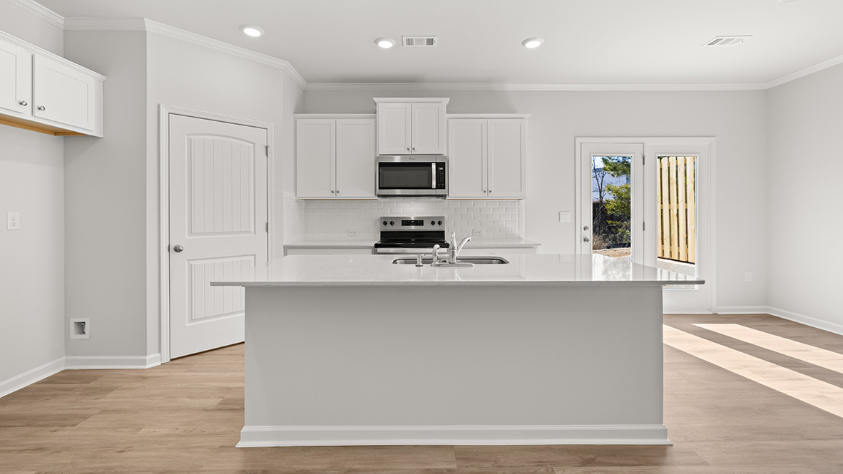 Interior kitchen with center island and white cabinets
