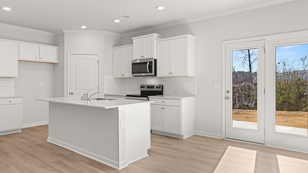 Interior kitchen with center island and white cabinets