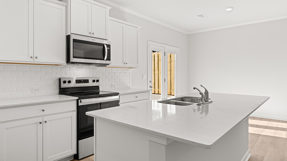 Interior kitchen with center island and white cabinets