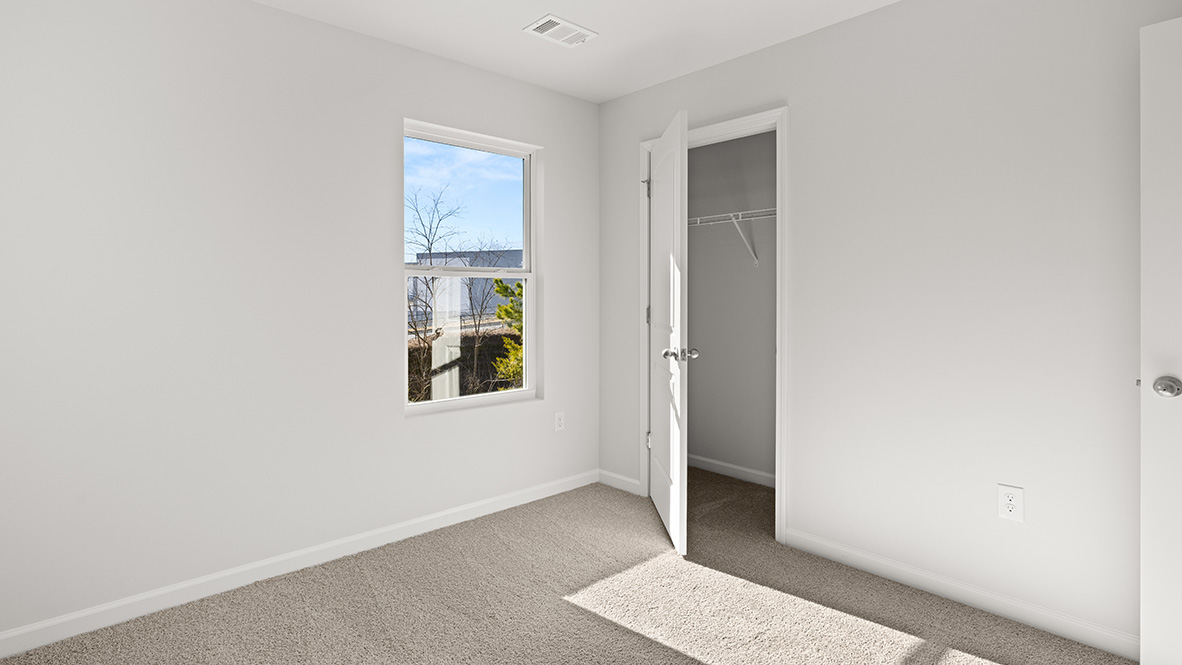 Interior bedroom with window and closet