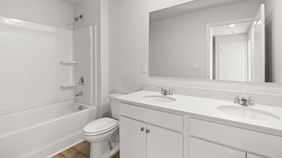 Interior bathroom with double sink and full-sized shower