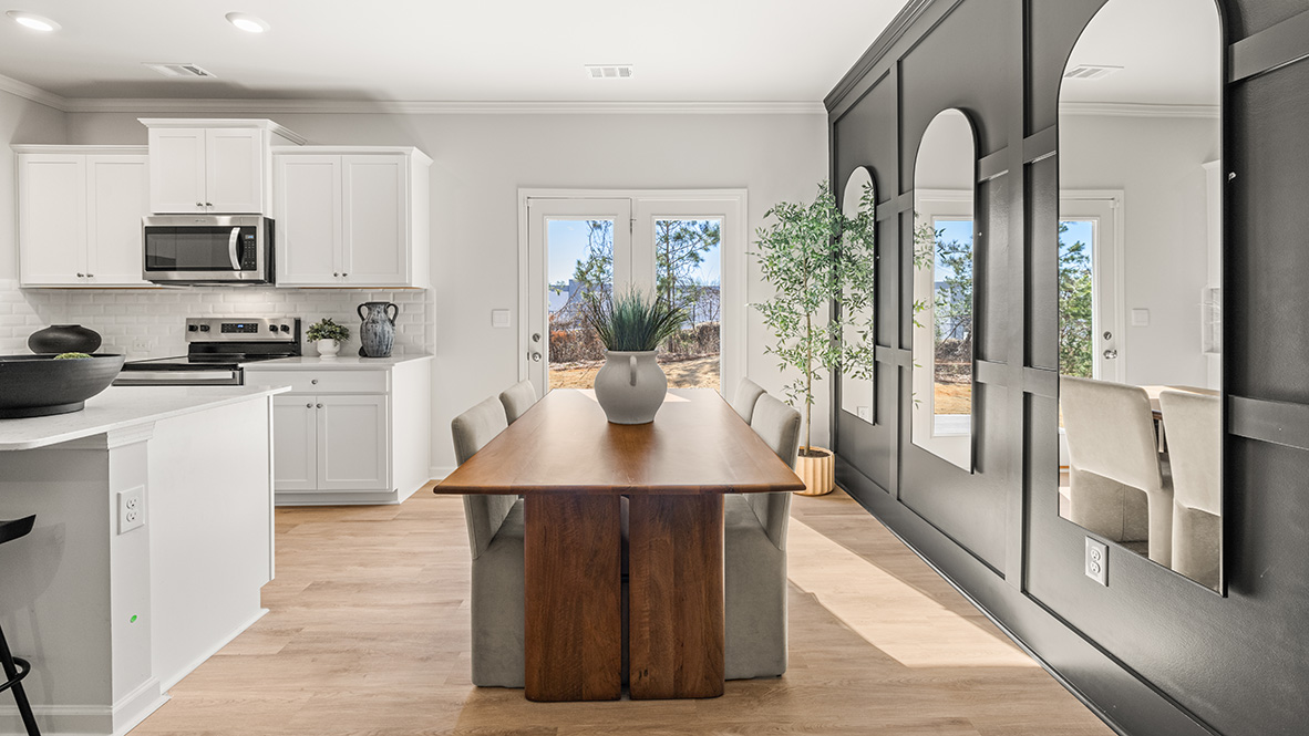 dining room featuring a wooden table and 4 upholstered chairs around it