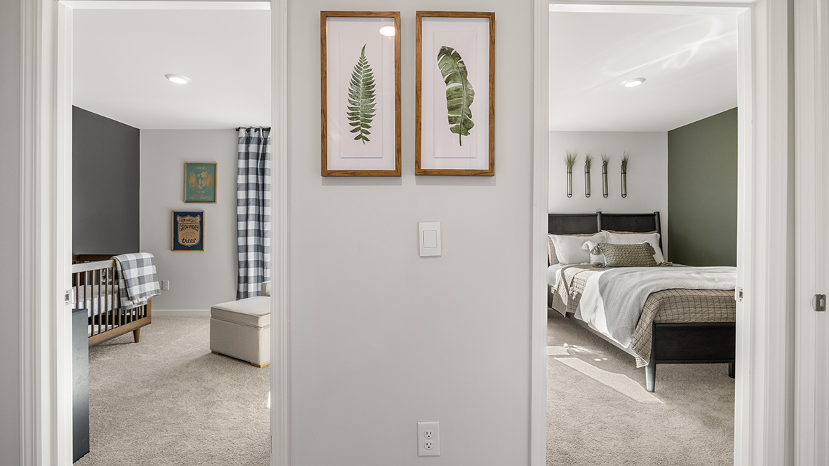 hallway view of two side by side bedrooms
