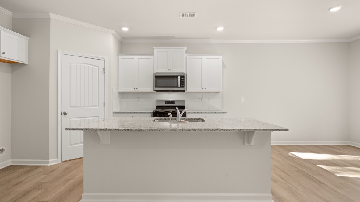 Interior kitchen with center island with white cabinets