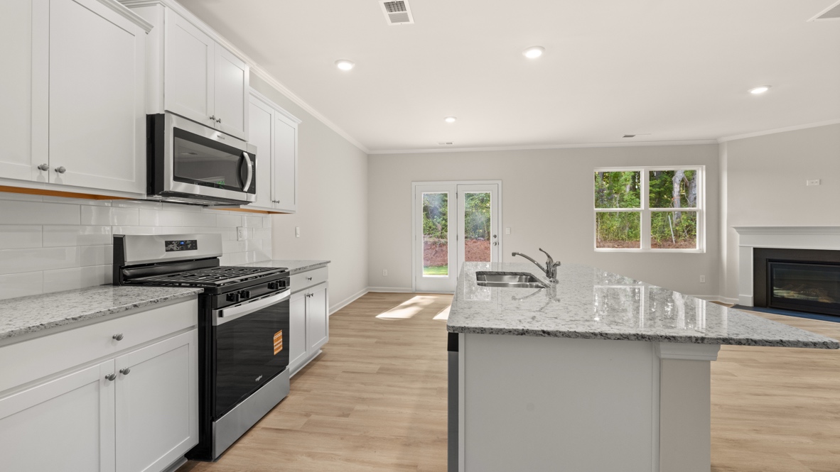 Interior kitchen with center island with white cabinets