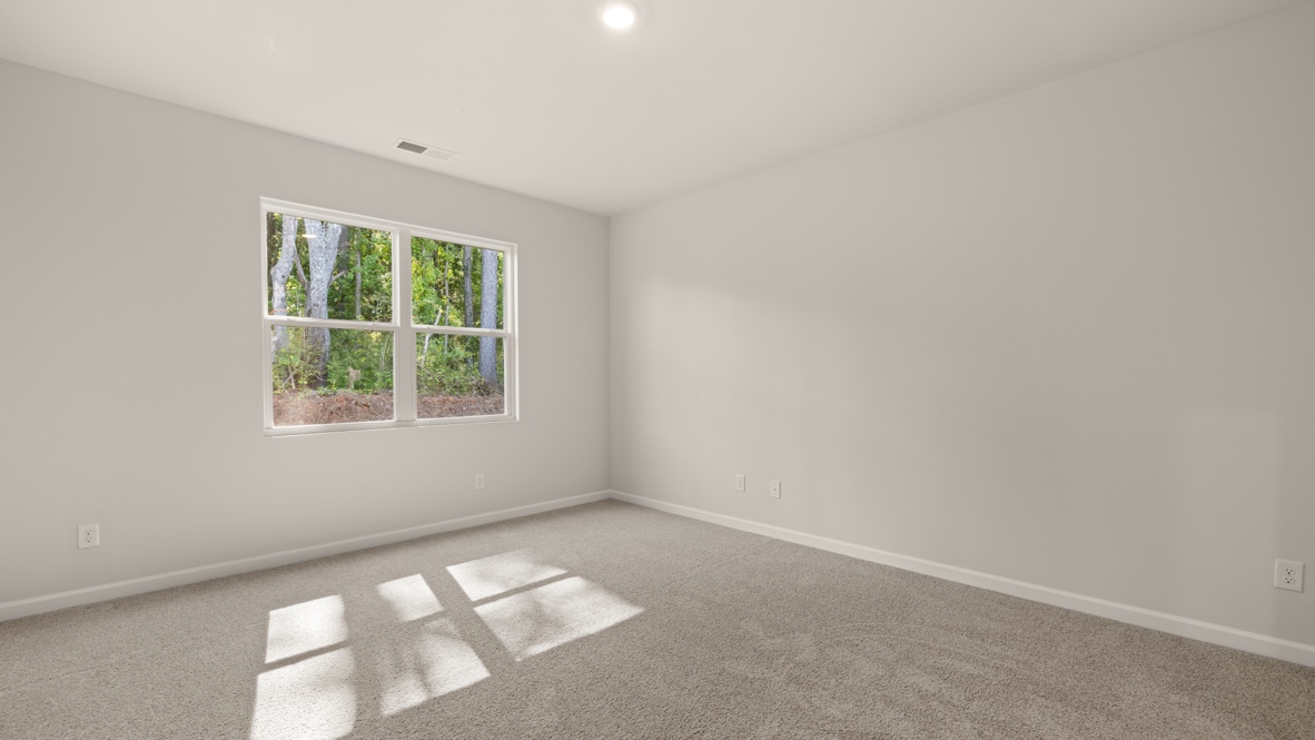 Interior primary bedroom with large window